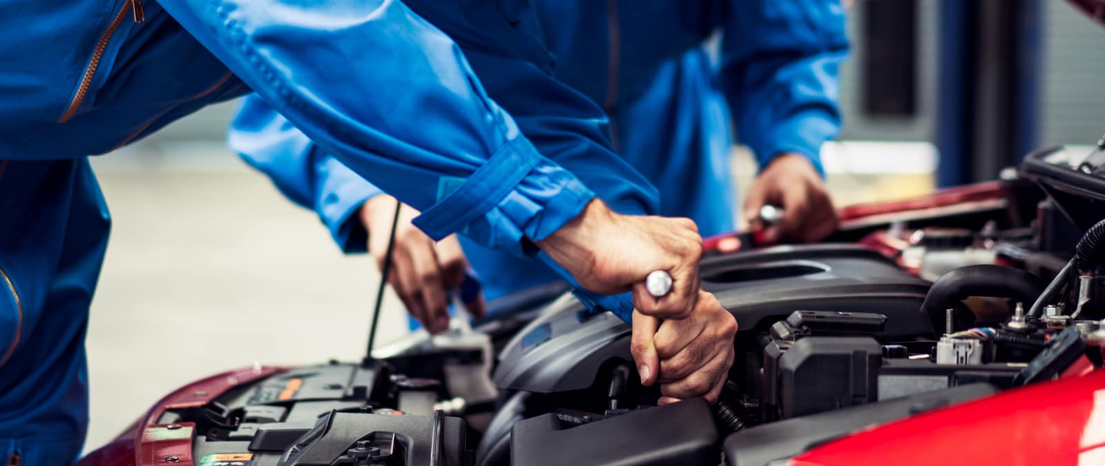 Mechanic working under the bonnet of a vehicle